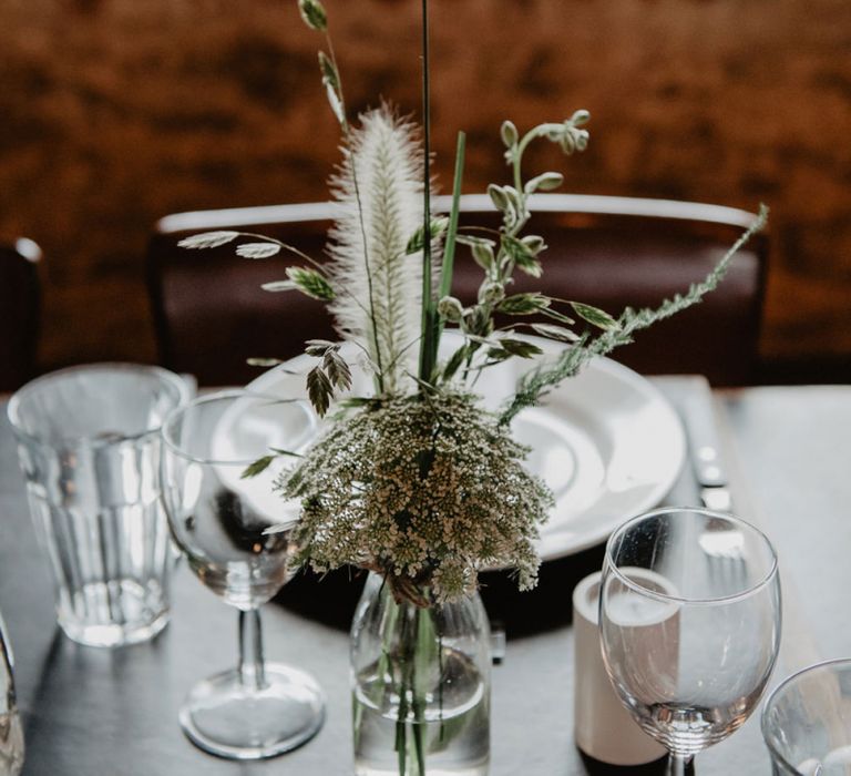 White and Green Wedding Flowers in Glass Bottles