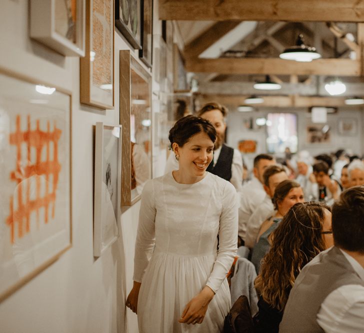 Bride in Homemade Wedding Dress with Long Sleeves Entering the Wedding Reception