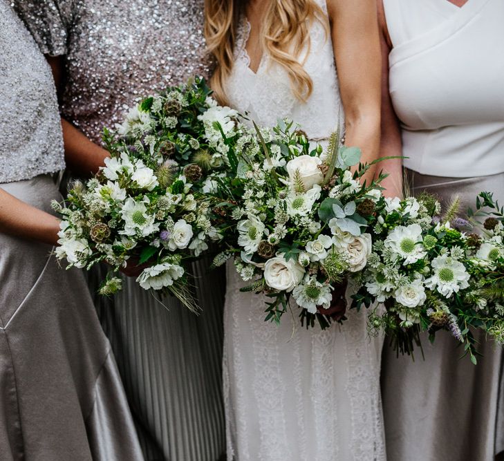 Bridal Party Bouquets | Bridesmaids in Metallic Silver Skirts &amp; Sequin Tops | Bride in Charlie Brear Delancey Gown &amp; Belt | Groom in Hugo Boss Suit | Quirky Pub Wedding at The Bell in Ticehurst East Sussex | Epic Love Story Photography