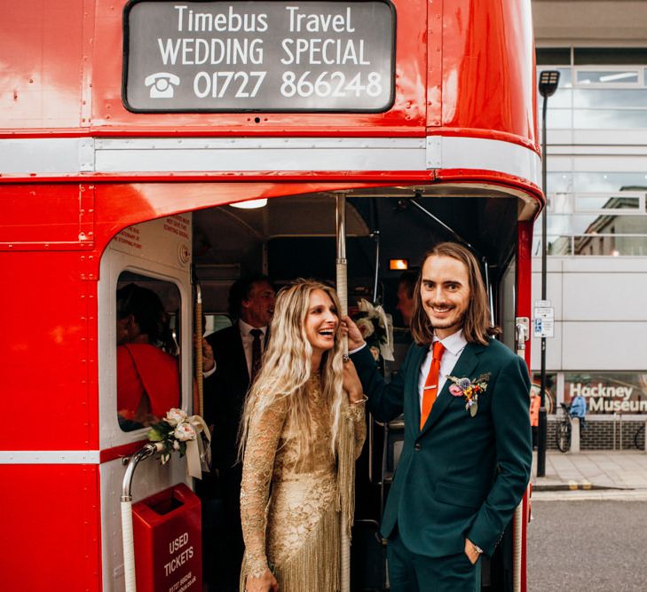 Bride and Groom on Red London Bus for Wedding Transport