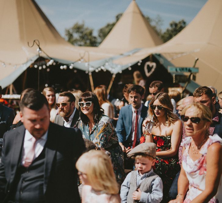 Guests at an outdoor tipi wedding