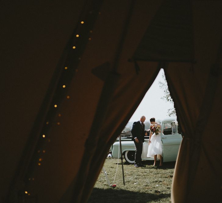 Bride and groom through the tipi