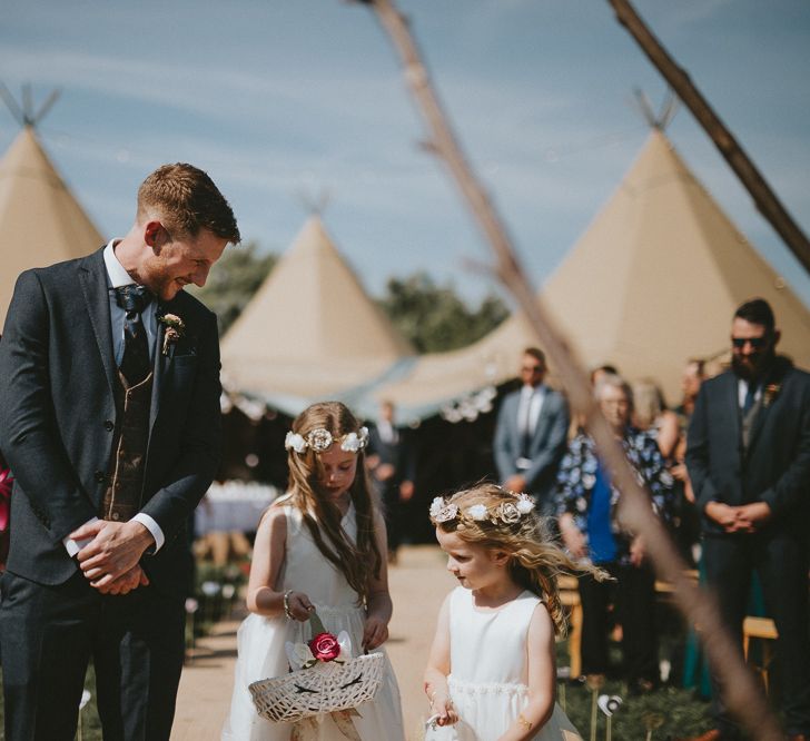 Groom and flowergirls waiting for bride