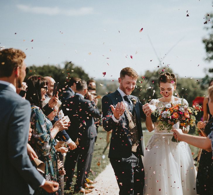 Bride and groom congratulated by guests