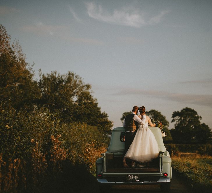 Bride and groom with vintage chevy truck