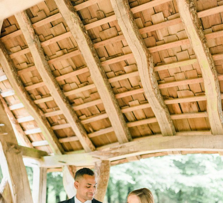 Wedding Ceremony with Bride in Beaded Wedding Dress and Groom in Dark Suit &amp; Check Waistcoat