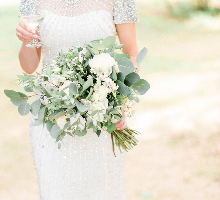 Bride in Jenny Packham Beaded Wedding Dress Holding White and Green Wedding Bouquet