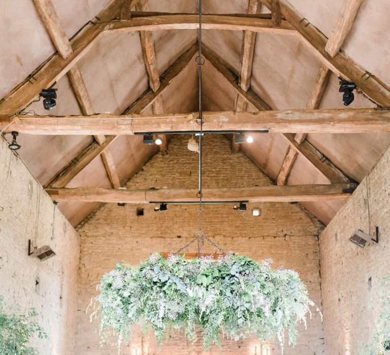 Cripps Barn Wedding Venue with Foliage Fireplace Decor and Hanging Hoop Chandelier