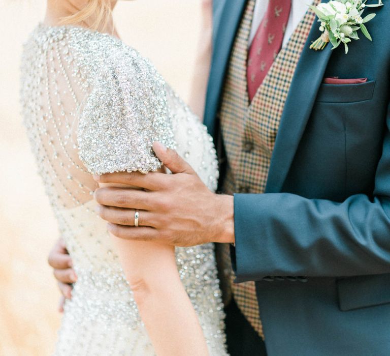 Bride in Beaded Wedding Dress and Groom in Dark Suit &amp; Check Waistcoat