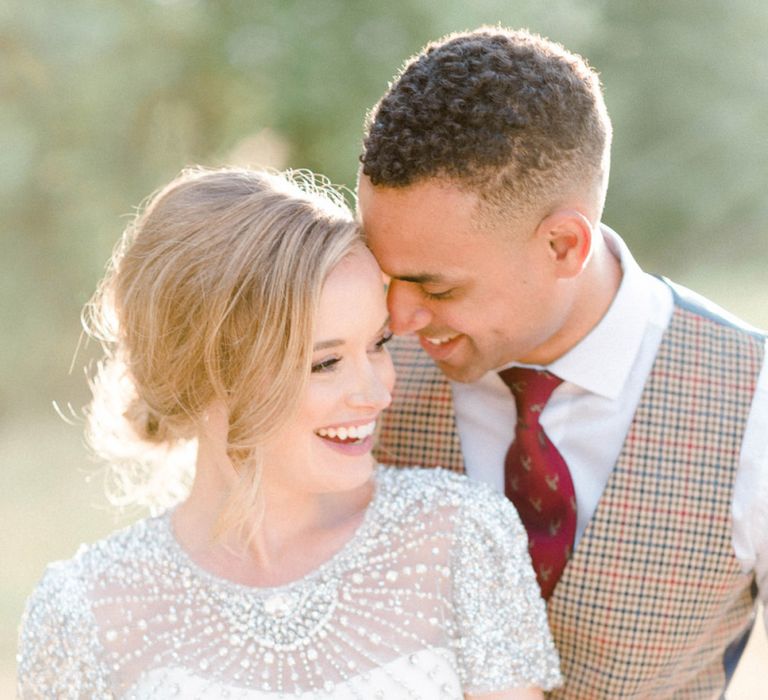 Golden Hour Portrait with Bride in Beaded Wedding Dress and Groom in Dark Suit &amp; Check Waistcoat