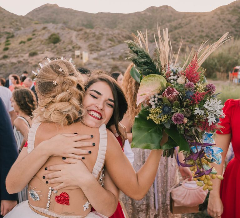 Bride hugging guest