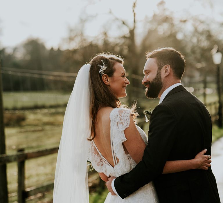 Bride in lace wedding dress with long veil