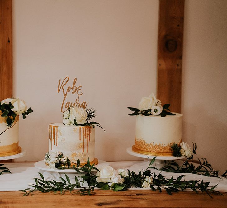 Separate wedding cakes with gold detail