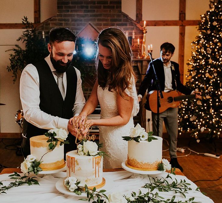 Bride and groom cut the wedding cake