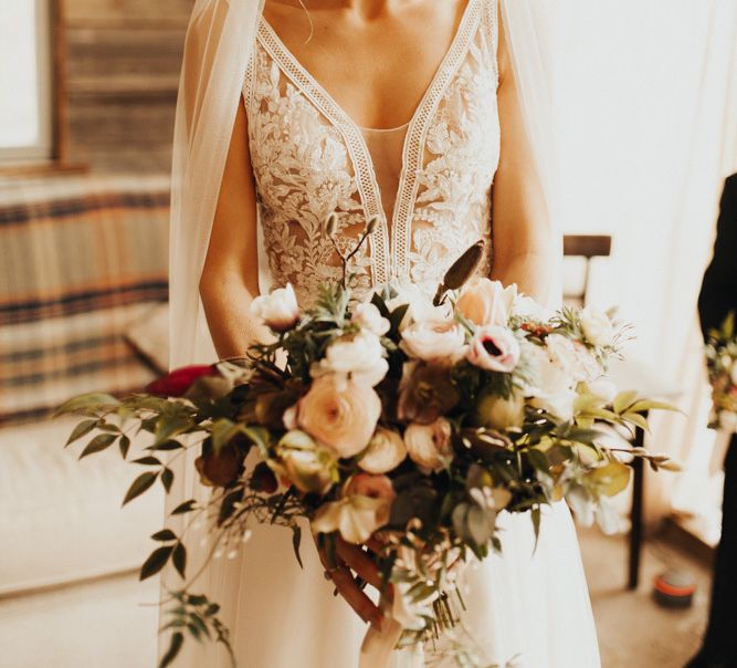 Lace detail wedding dress with veil and blush bouquet