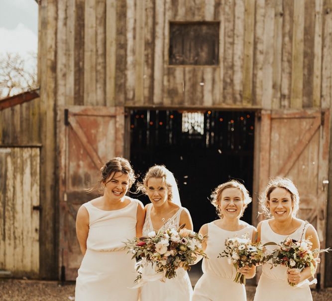 Bride with bridal party in blush bridesmaid dresses