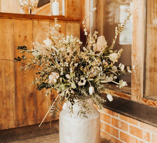 Wedding flowers in rustic milk churn