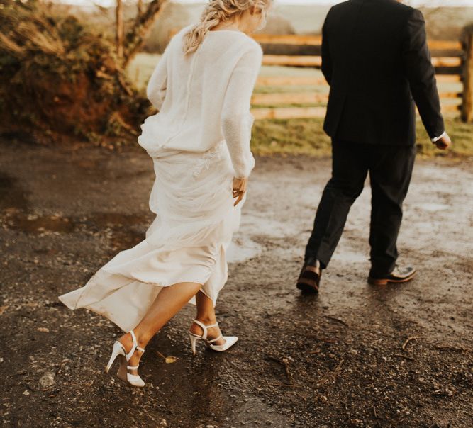 Bride with braided updo and bridal jumper