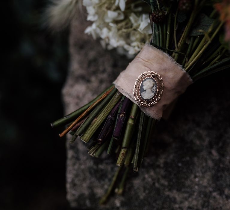 Cameo brooch on wedding bouquet