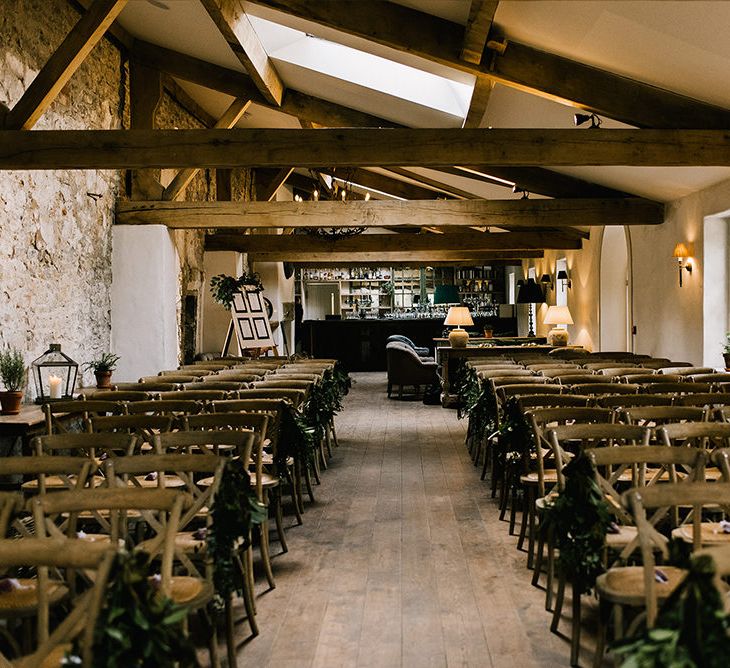 Foliage Pew Ends | Rustic Wooden Chairs | Wedding Ceremony in The Boiler House Bar at Middleton Lodge | Emerald Green Bridesmaid Dress for a Winter Wedding at Middleton Lodge | Georgina Harrison Photography