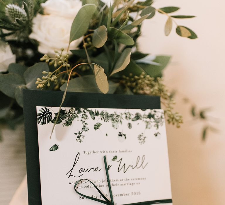 White and Green Wedding Invitation Tied with Ribbon | Emerald Green Bridesmaid Dress for a Winter Wedding at Middleton Lodge | Georgina Harrison Photography