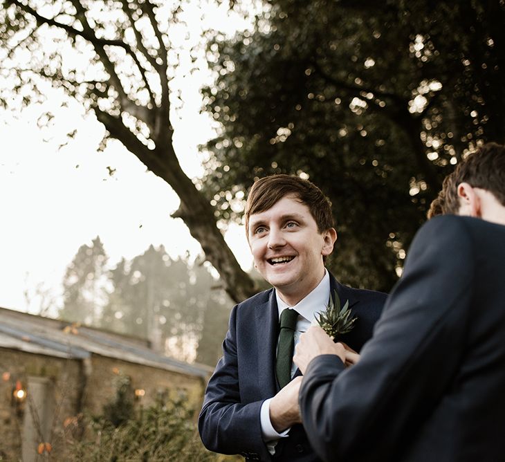 Groom in Navy Three-Piece Suit from Suit Supply with Green Tie | Emerald Green Bridesmaid Dress for a Winter Wedding at Middleton Lodge | Georgina Harrison Photography