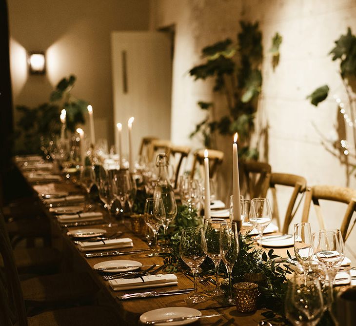 Wooden Banquet Tables | Foliage Table Runners | White Tapered Candles | Gold Candlesticks | Gold Tea Light Holders | Emerald Green Bridesmaid Dress for a Winter Wedding at Middleton Lodge | Georgina Harrison Photography