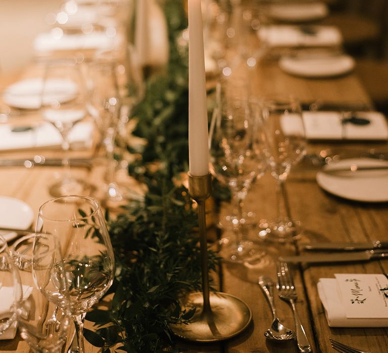 Wooden Banquet Tables | Foliage Table Runners | White Tapered Candles | Gold Candlesticks | Emerald Green Bridesmaid Dress for a Winter Wedding at Middleton Lodge | Georgina Harrison Photography