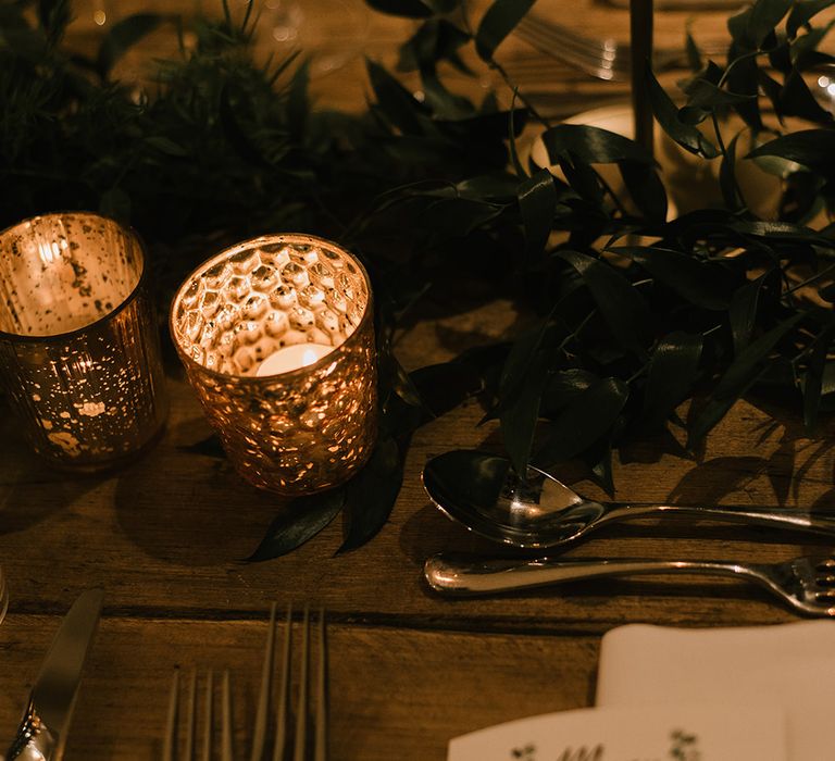 Gold Tea Light Holders | Foliage Table Runners | White Tapered Candles | Gold Candlesticks | Emerald Green Bridesmaid Dress for a Winter Wedding at Middleton Lodge | Georgina Harrison Photography