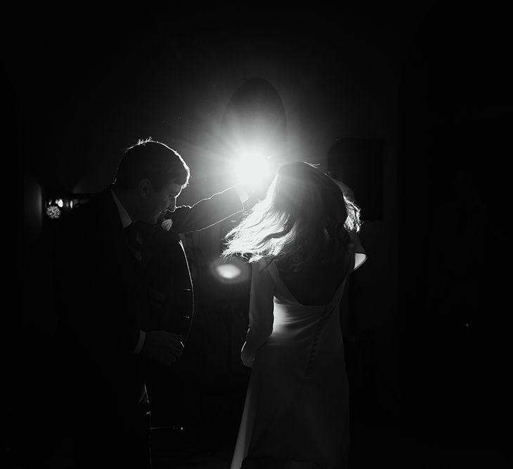 Bride in Long Sleeved Andrea Hawkes Dress with Bateau Neck and Low V-Back with Buttons | Groom in Navy Three-Piece Suit from Suit Supply with Green Tie | First Dance | Emerald Green Bridesmaid Dress for a Winter Wedding at Middleton Lodge | Georgina Harrison Photography