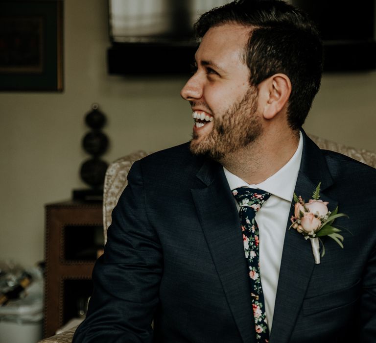 Groom in Navy Suit and Floral Tie | Pink Buttonhole | Rifle Paper Co. Trainers for Informal Wedding in Fort Worth, Texas | Paul &amp; Nanda Photography