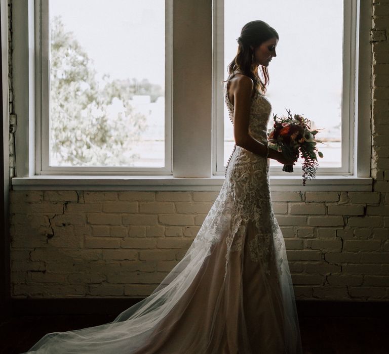 Bride in Sleeveless High-Neck Stella York Gown with Lace Overlay and Gold Underskirt | Half Up Half Down Wedding Hair | Colourful Bridal Bouquet of Pink, Orange and White Flowers with Ferns, Eucalyptus and Greenery | Rifle Paper Co. Trainers for Informal Wedding in Fort Worth, Texas | Paul &amp; Nanda Photography