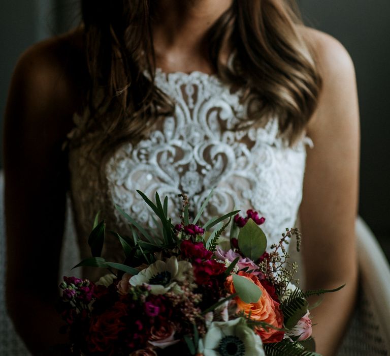 Bride in Sleeveless High-Neck Stella York Gown with Lace Overlay and Gold Underskirt | Half Up Half Down Wedding Hair | Bride Wearing Red Lipstick | Colourful Bridal Bouquet of Pink, Orange and White Flowers with Ferns, Eucalyptus and Greenery | Rifle Paper Co. Trainers for Informal Wedding in Fort Worth, Texas | Paul &amp; Nanda Photography