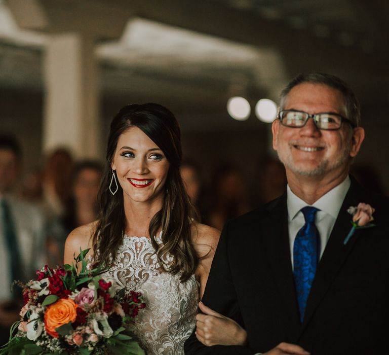 Arrival of the Bride | Bride in Sleeveless High-Neck Stella York Gown with Lace Overlay and Gold Underskirt | Half Up Half Down Wedding Hair | Bride Wearing Red Lipstick | Colourful Bridal Bouquet of Pink, Orange and White Flowers with Ferns, Eucalyptus and Greenery | Rifle Paper Co. Trainers for Informal Wedding in Fort Worth, Texas | Paul &amp; Nanda Photography