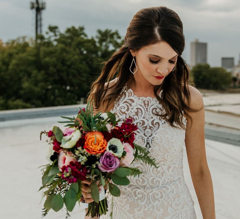 Bride in Sleeveless High-Neck Stella York Gown with Lace Overlay and Gold Underskirt | Half Up Half Down Wedding Hair | Bride Wearing Red Lipstick | Colourful Bridal Bouquet of Pink, Orange and White Flowers with Ferns, Eucalyptus and Greenery | Rifle Paper Co. Trainers for Informal Wedding in Fort Worth, Texas | Paul &amp; Nanda Photography