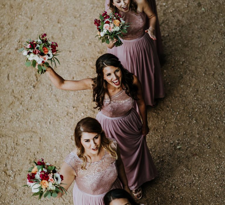 Bridesmaids in Pink Dresses with Lace Bodice | Colourful Bouquets of Pink, Orange and White Flowers with Ferns, Eucalyptus and Greenery | Rifle Paper Co. Trainers for Informal Wedding in Fort Worth, Texas | Paul &amp; Nanda Photography