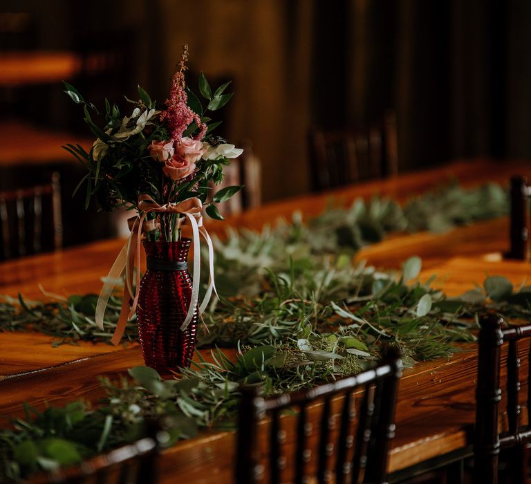 Wedding Reception Décor | Pinwheel Table Configuration | Eucalyptus Garland | Pink Flowers and Foliage in Red Vase | Rifle Paper Co. Trainers for Informal Wedding in Fort Worth, Texas | Paul &amp; Nanda Photography