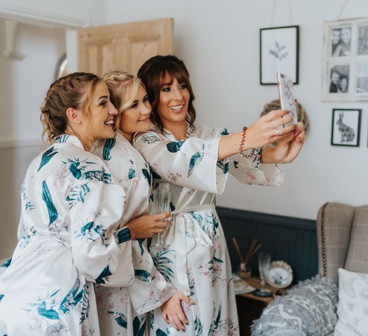 Bridal preparations with bridal party in matching getting ready robes