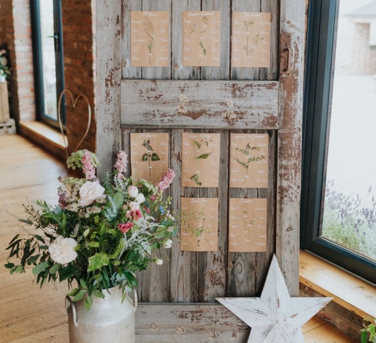 DIY wedding decor with rustic seating chart and flower decor