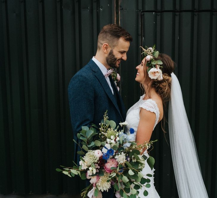 Bride wears flower crown with large bouquet