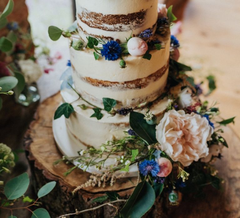 Semi-naked wedding cake at celebration with DIY wedding decor