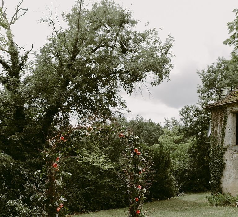 Floral Arch, Persian Rug &amp; Lanterns Wedding Decor | Outdoor Boho Wedding at Chateau le Tour, France | Adam and Grace Photography | Head and Heart Films