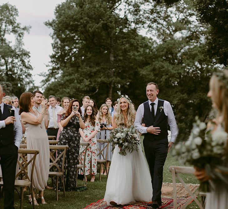 Outdoor Wedding Ceremony | Bridal Entrance in Daarlarna Wedding Dress | Persian Rug, &amp; Floral Arch Aisle &amp; Altar Wedding Decor | Outdoor Boho Wedding at Chateau le Tour, France | Adam and Grace Photography | Head and Heart Films