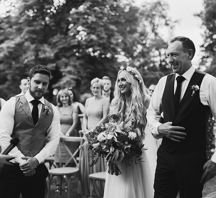 Outdoor Wedding Ceremony | Bridal Entrance in Daarlarna Wedding Dress | Persian Rug, &amp; Floral Arch Aisle &amp; Altar Wedding Decor | Outdoor Boho Wedding at Chateau le Tour, France | Adam and Grace Photography | Head and Heart Films