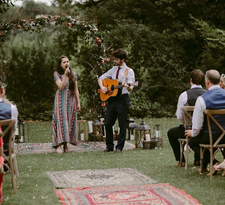 Wedding Ceremony | Persian Rug &amp; Floral Arch Wedding Decor | Outdoor Boho Wedding at Chateau le Tour, France | Adam and Grace Photography | Head and Heart Films