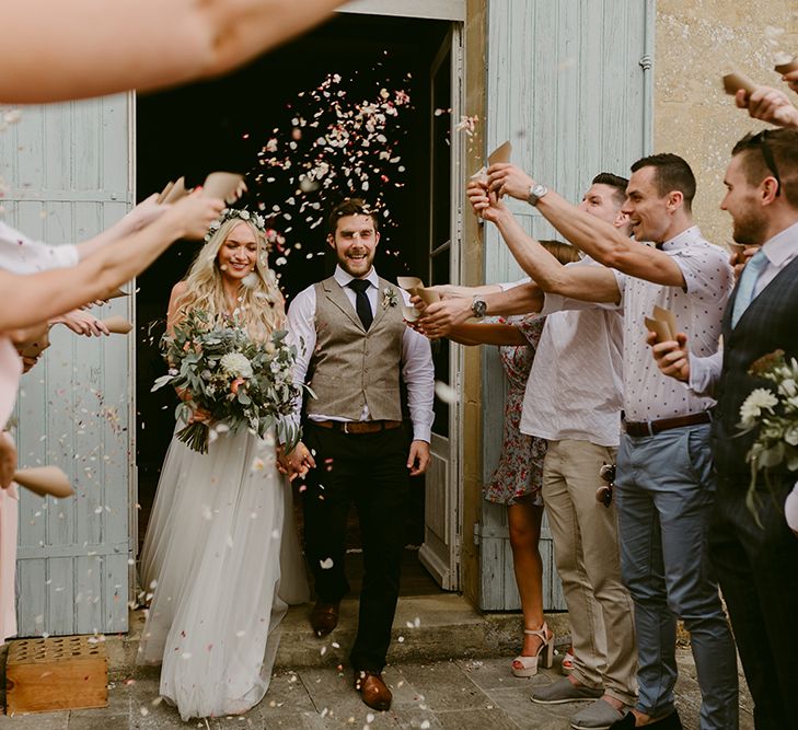 Confetti Exit | Bride in Daalarna Bridal Gown | Groom in Waistcoat | Outdoor Boho Wedding at Chateau le Tour, France | Adam and Grace Photography | Head and Heart Films