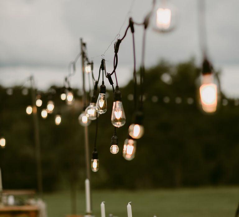 Edison Bulbs Wedding Lighting | Outdoor Boho Wedding at Chateau le Tour, France | Adam and Grace Photography | Head and Heart Films