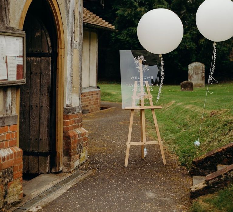 Acrylic wedding sign with balloons at church ceremony