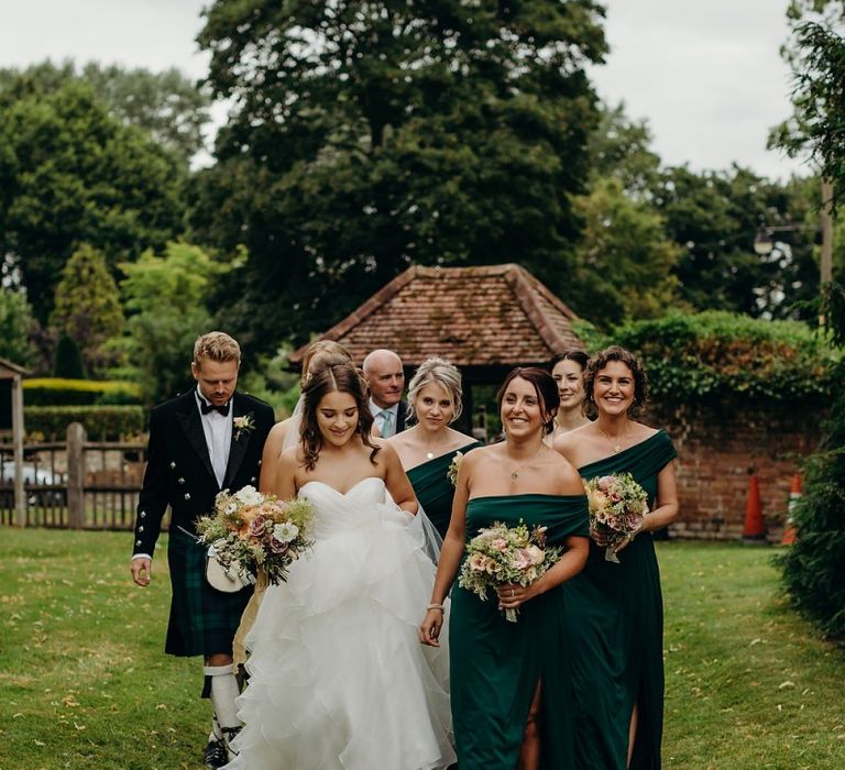 Bride in layered wedding dress makes her way to ceremony