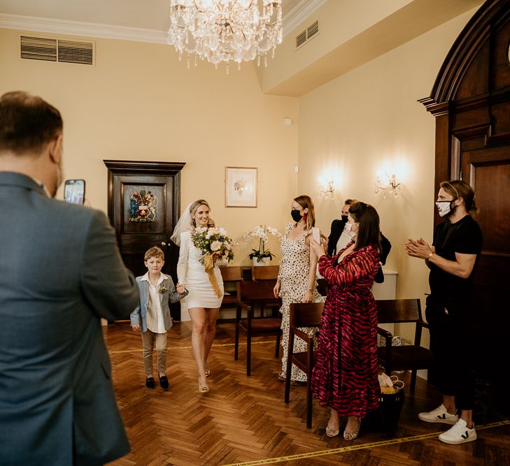 Bride walking down the aisle with her son